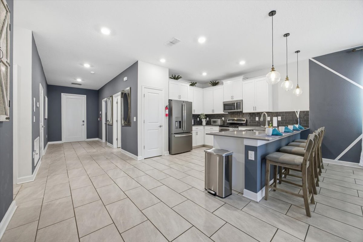 Kitchen with island seating and foyer