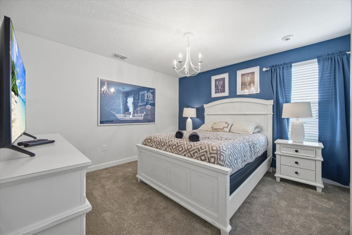Bedroom with white furniture and blue accent